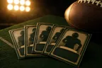 Football trading cards fanned on green felt beside a football
