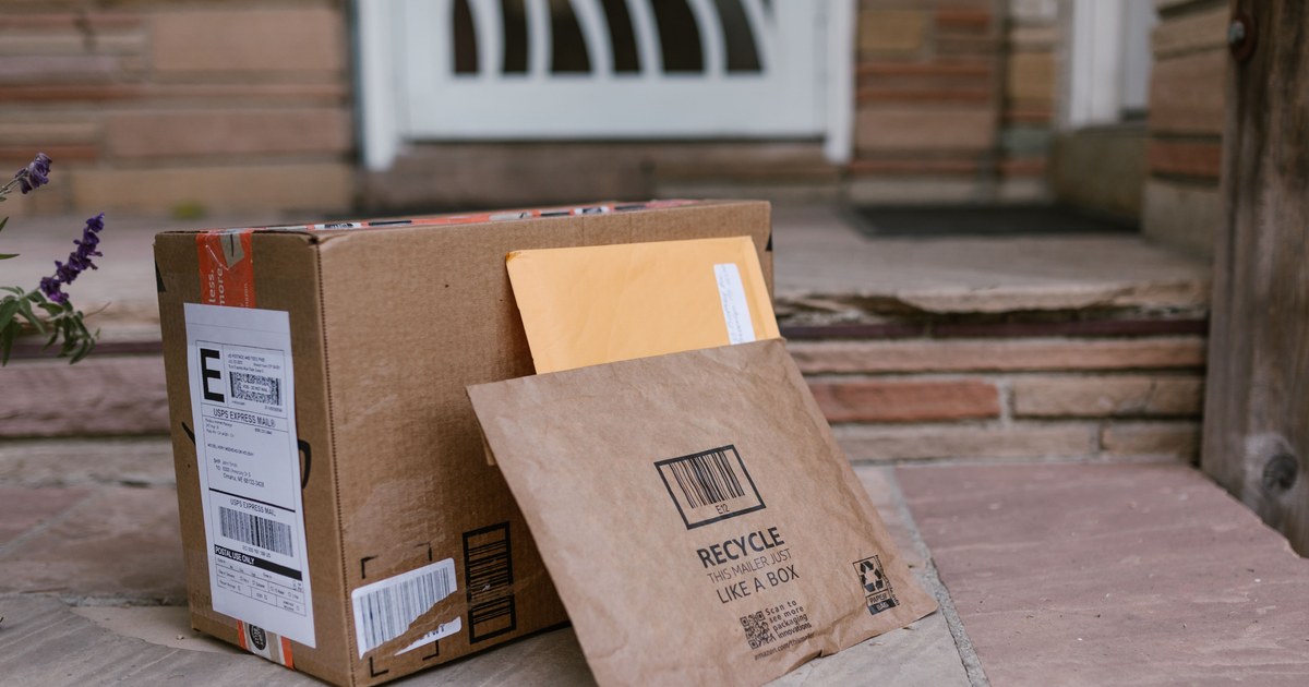 Packages and a padded mailer left on a doorstep after delivery