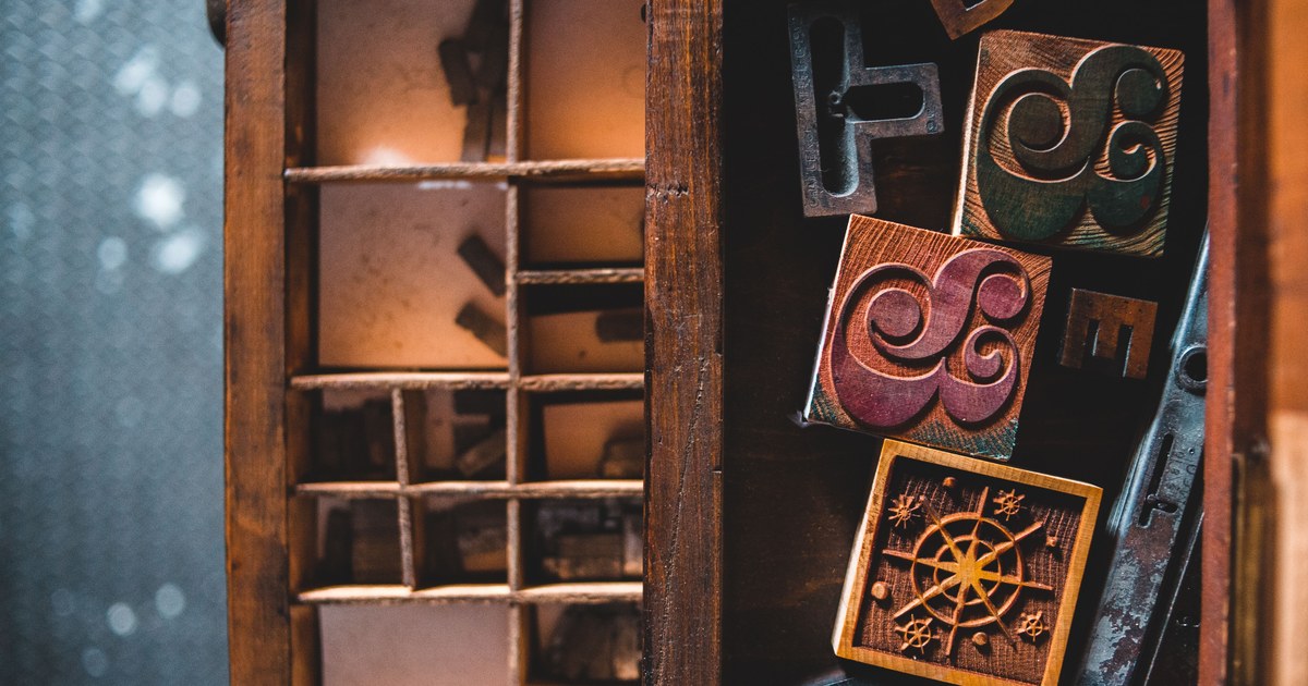 Old wooden cabinet drawers filled with vintage letterpress printing blocks