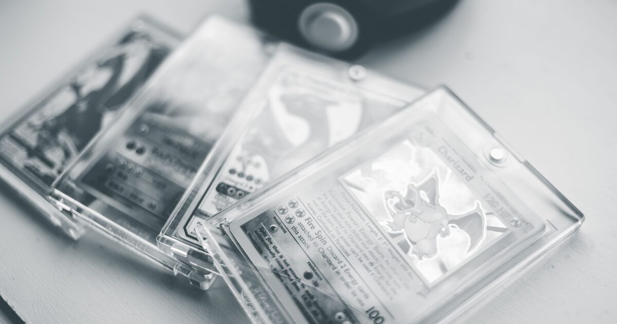 Black and white close-up of collectible trading cards sealed in hard protective cases